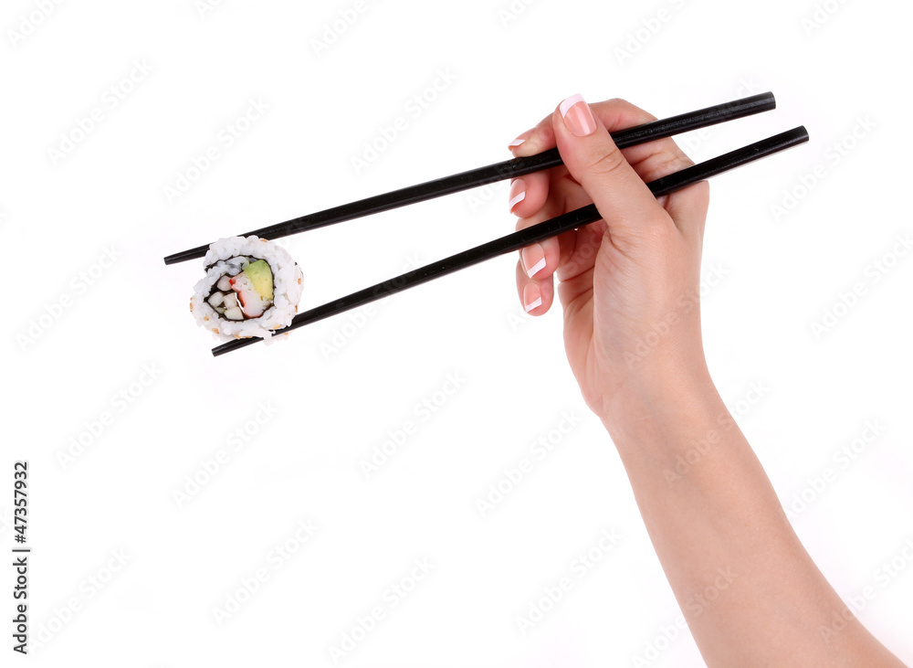 Sushi roll with black chopsticks in female hand isolated Sushi roll with black chopsticks in female hand isolated