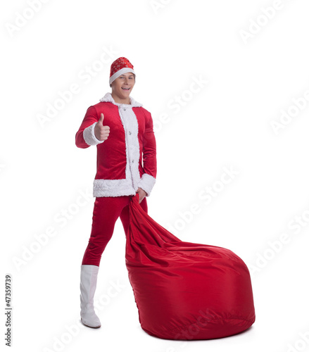 Happy young santa claus with huge red bag