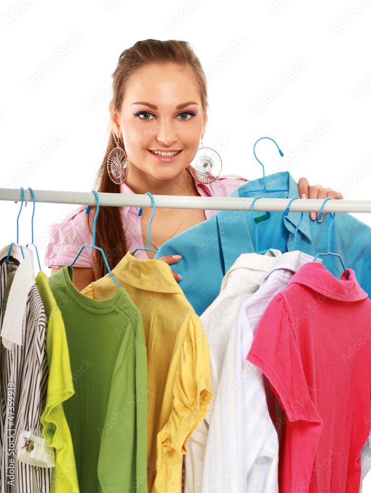 Stylish young girl trying on clothes in clothing store isolated Stylish young girl trying on clothes in clothing store isolated