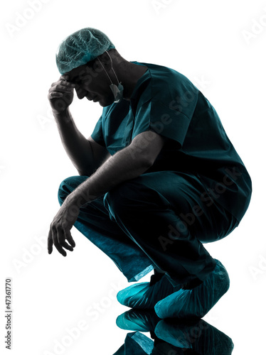 doctor surgeon man despair fatigue tired  silhouette photo