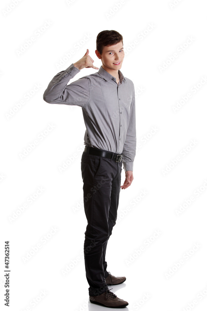 Young businessman showing call me sign Young businessman showing call me sign