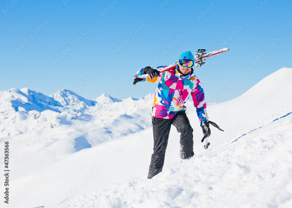 Young man with skis and a ski wear Young man with skis and a ski wear