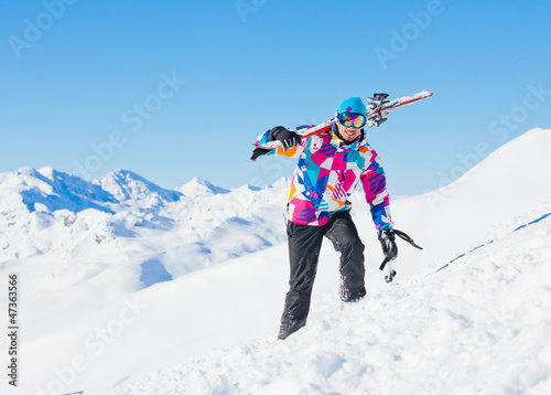 Young man with skis and a ski wear