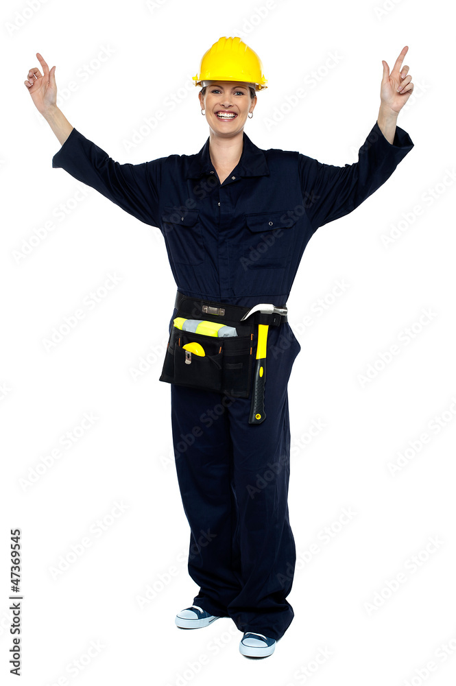 Smiling lady worker in jumpsuit raising her hands Smiling lady worker in jumpsuit raising her hands