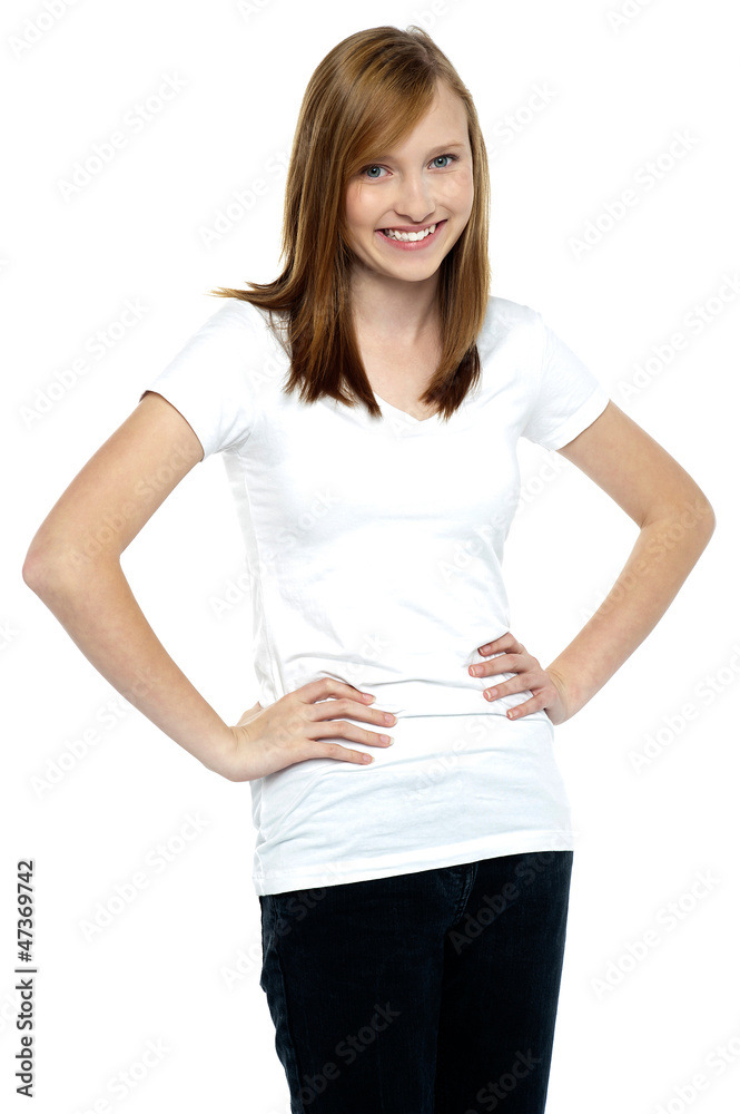 Attractive teenager posing casually, hands on waist Attractive teenager posing casually, hands on waist