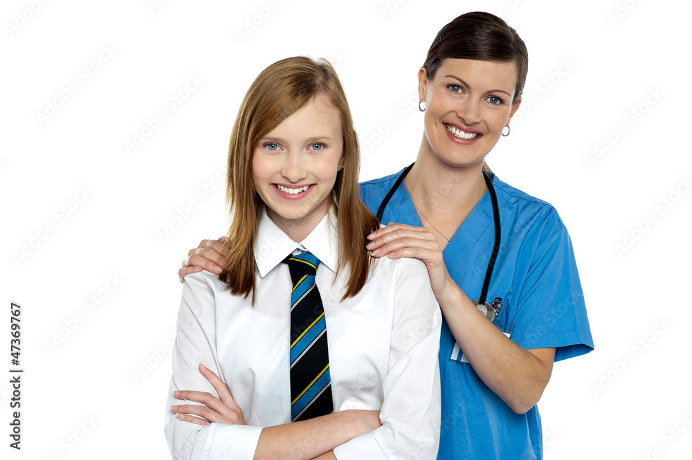 Graceful doctor posing with her teenage patient Graceful doctor posing with her teenage patient