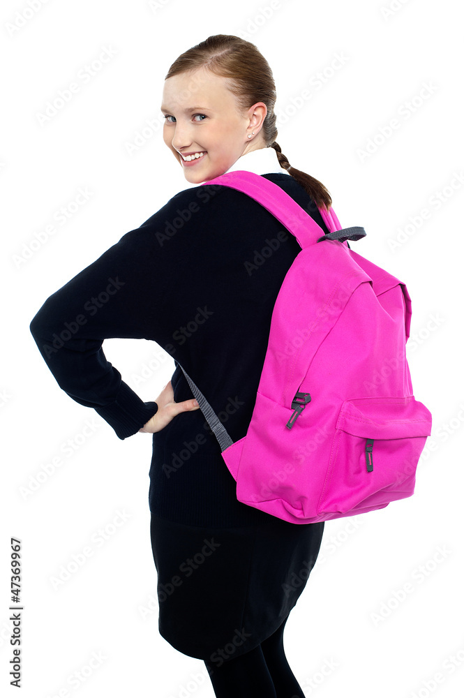 Teen girl turning back and passing smile to you Teen girl turning back and passing smile to you