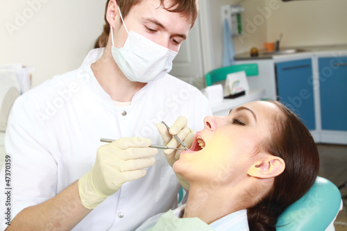 Young woman with dentist in a dental surgery