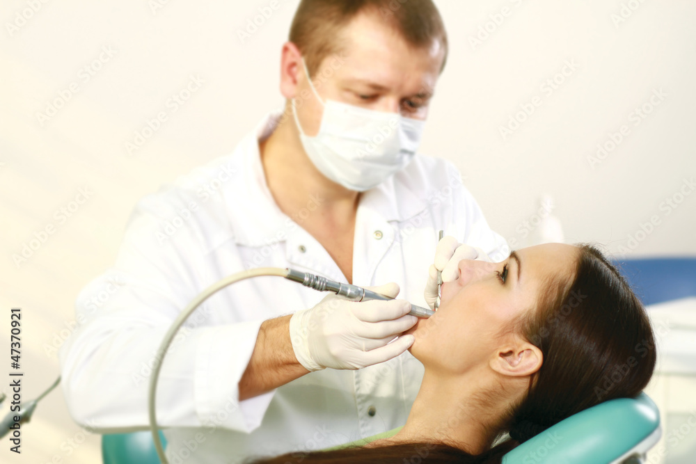 Young woman with dentist in a dental surgery Young woman with dentist in a dental surgery