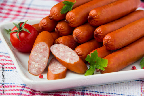Sausages on plate with cherry tomato
