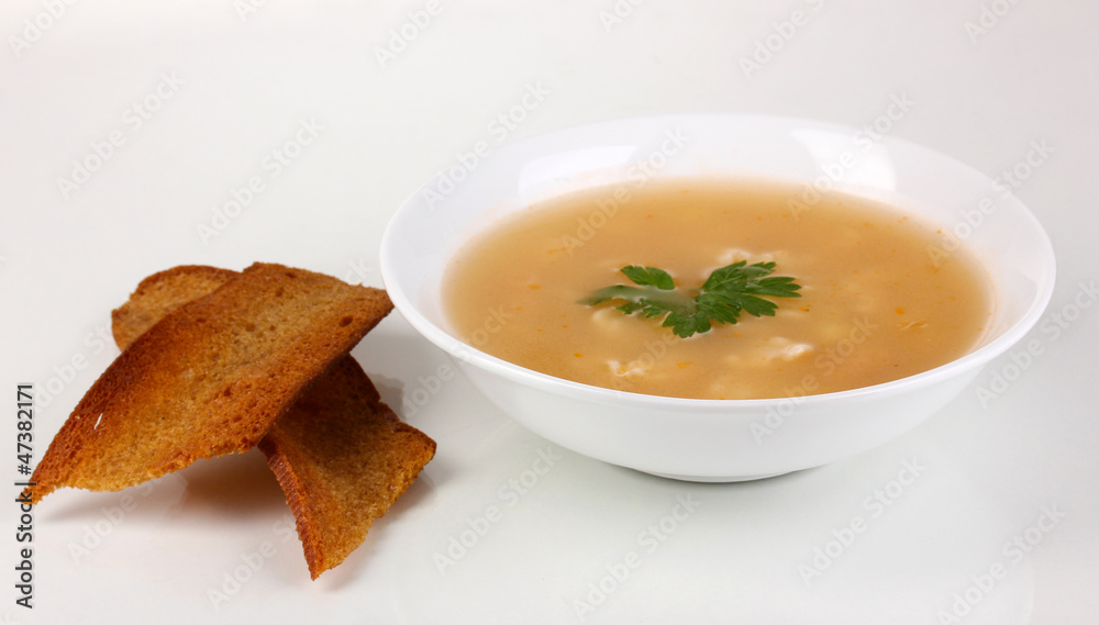 Fragrant soup with garlic croutons isolated on white Fragrant soup with garlic croutons isolated on white