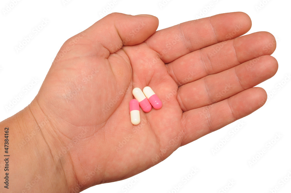 Hand holding pills Hand holding pills