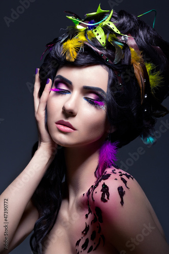 Fantasy. Fashion Female with Colorful Feathers - Bright Makeup