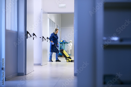 Women at workplace, professional female cleaner washing floor in