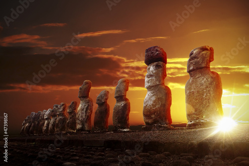 Mysterious stone statues at dramatic sunrise photo