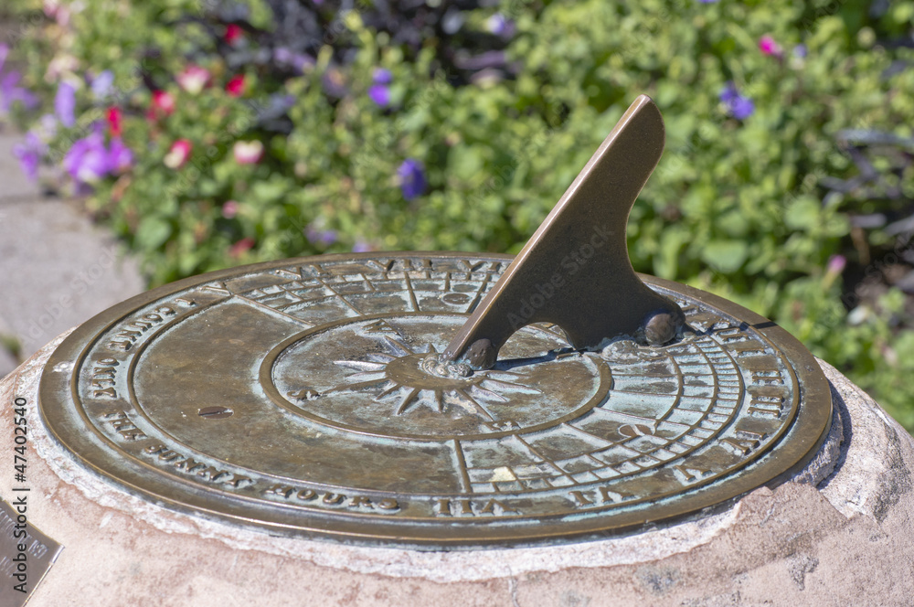 Old bronze sundial and shadow