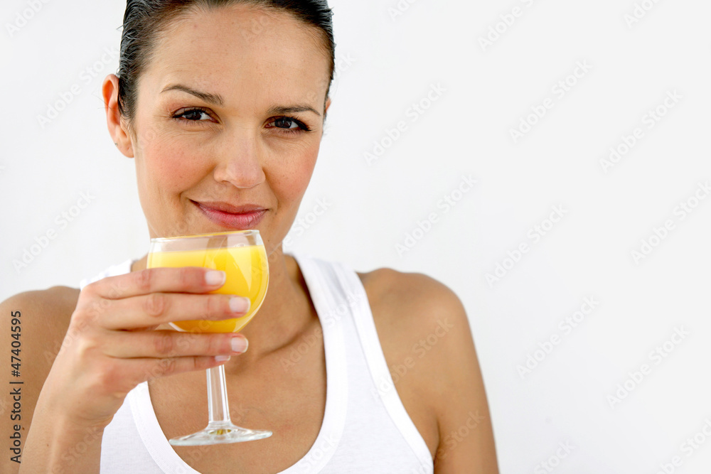 Woman having refreshing glass of orange juice Woman having refreshing glass of orange juice
