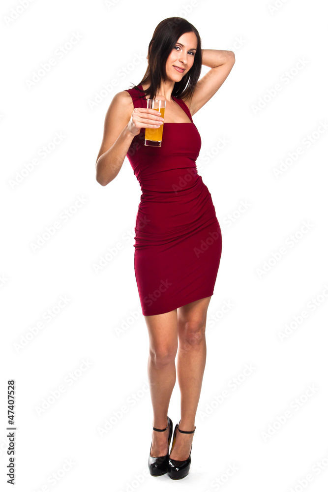 beautiful young woman in a red evening gown with a glass of juic beautiful young woman in a red evening gown with a glass of juic
