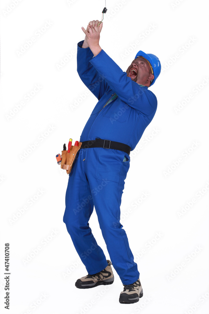 Fototapeta premium clumsy laborer getting electrocuted