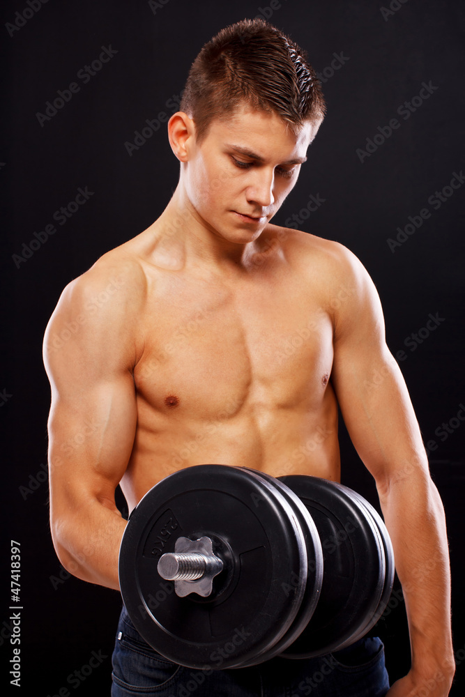 Portrait of handsome man posing on black background