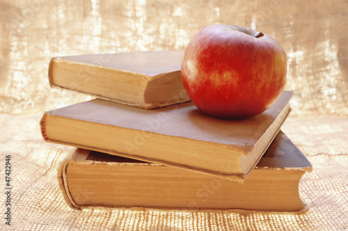Fresh red apple on a books