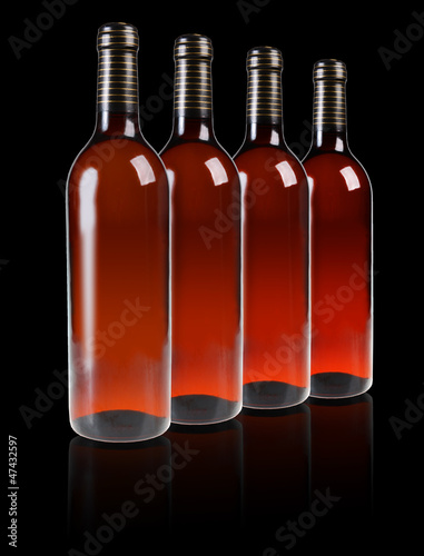 A row of bottles with red wine
