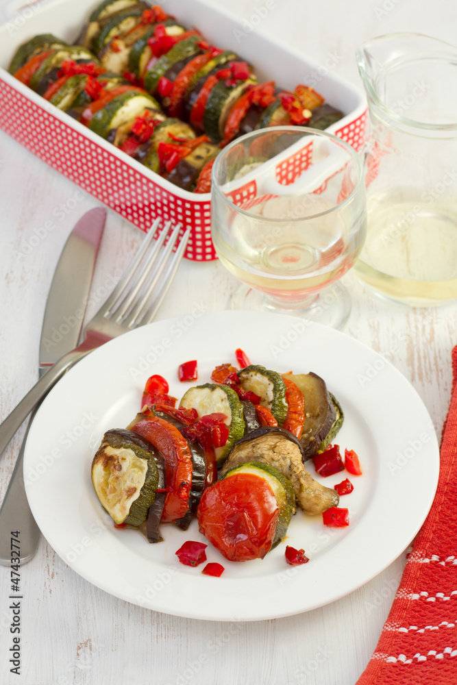 baked vegetables on the plate with fork and knife baked vegetables on the plate with fork and knife