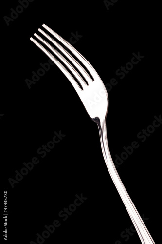 metal fork isolated on black background