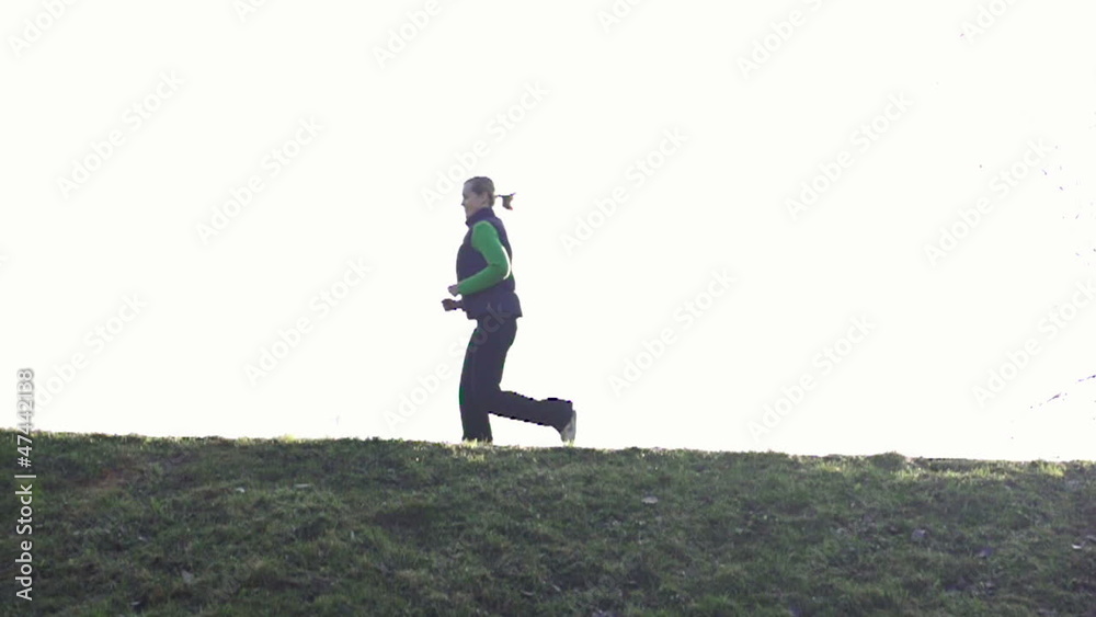 Man and woman jogging outdoors, super slow motion Man and woman jogging outdoors, super slow motion