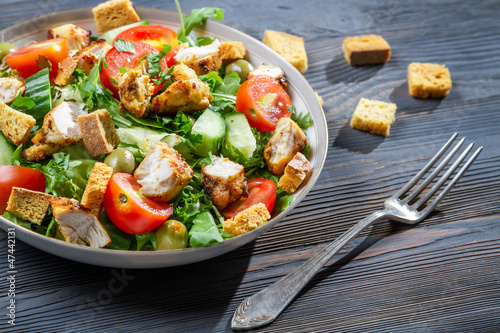 Healthy chicken salad with fresh vegetables and croutons