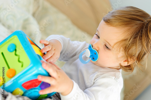 Fotografie Cute little boy playing with toy