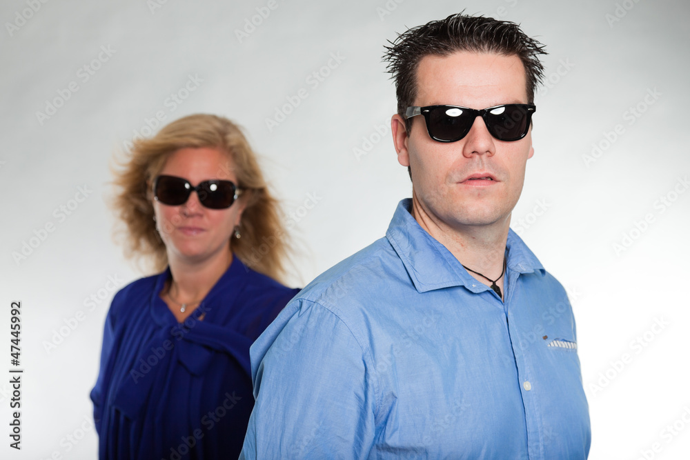 Fashion young couple with sunglasses. Studio shot.