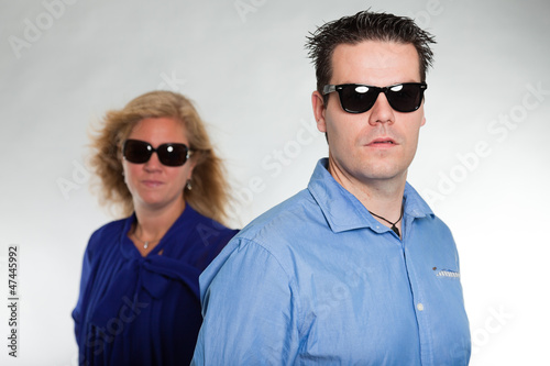 Obraz na płótnie Fashion young couple with sunglasses. Studio shot. w salonie