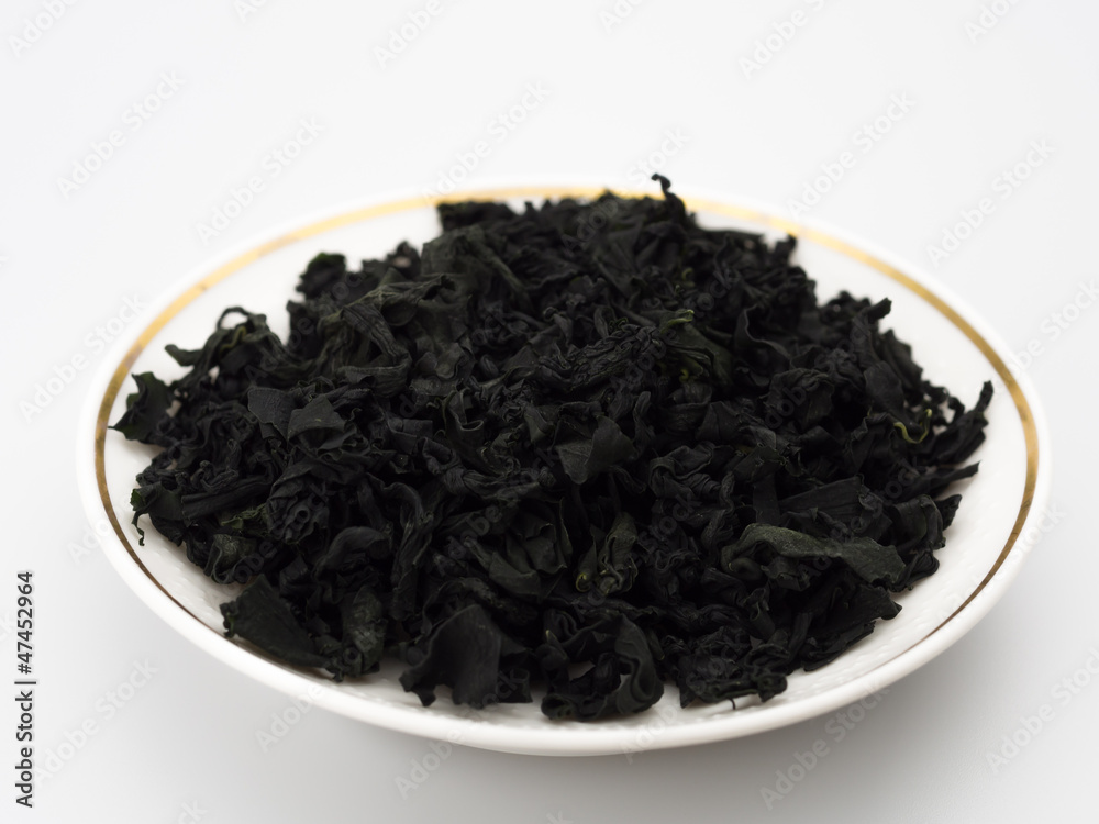 dried seaweed on a plate isolated white background dried seaweed on a plate isolated white background