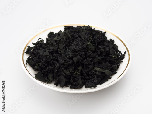 dried seaweed on a plate isolated white background