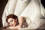 Vintage portrait of a glamourous queen like girl in bedroom