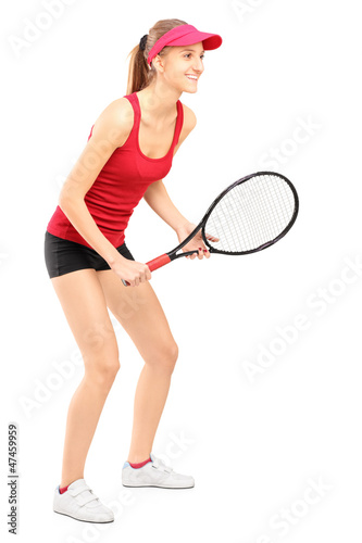 Full length portrait of female tennis player ready to play