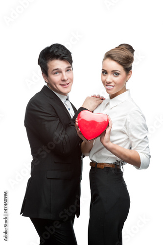 cheerful young business couple holding red heart