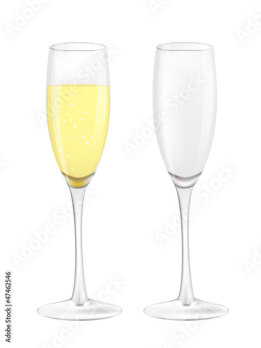 Two narrow glasses, one empty and one filled with champagne