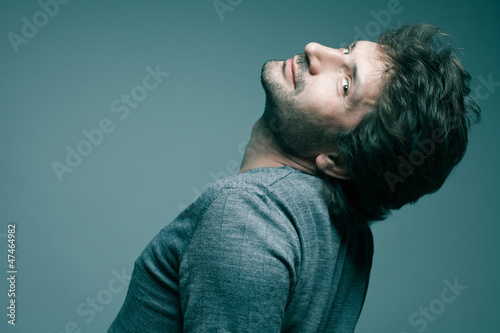 Portrait of a fashionable handsome model in gray sweater (pullov