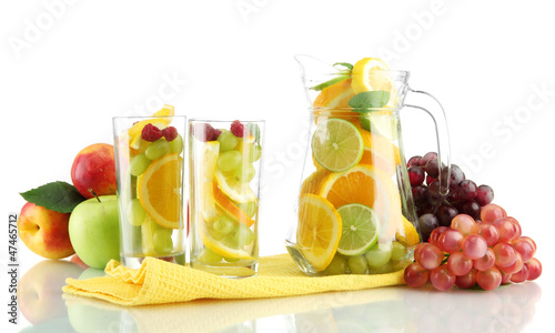 transparent jar and glasses with citrus fruits, isolated