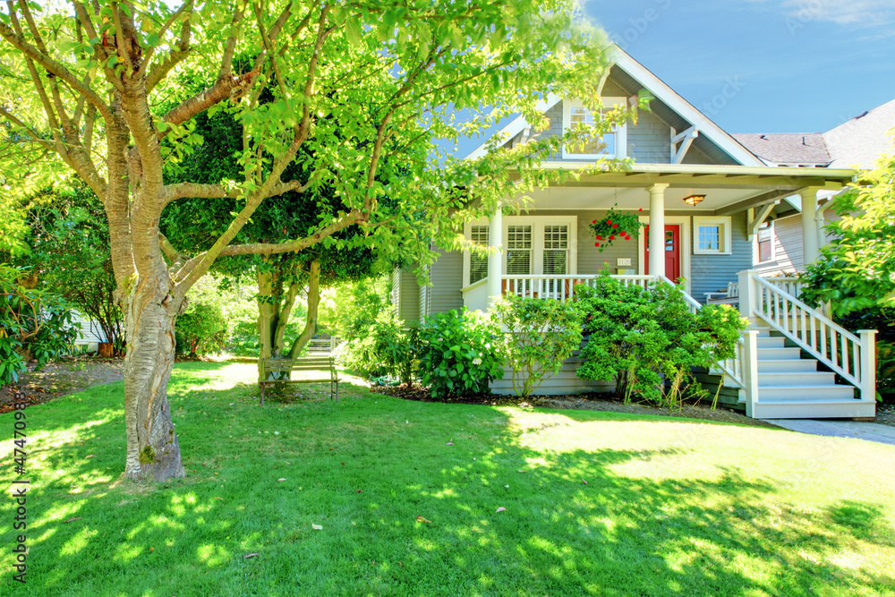 Grey old American house with summer landscape.