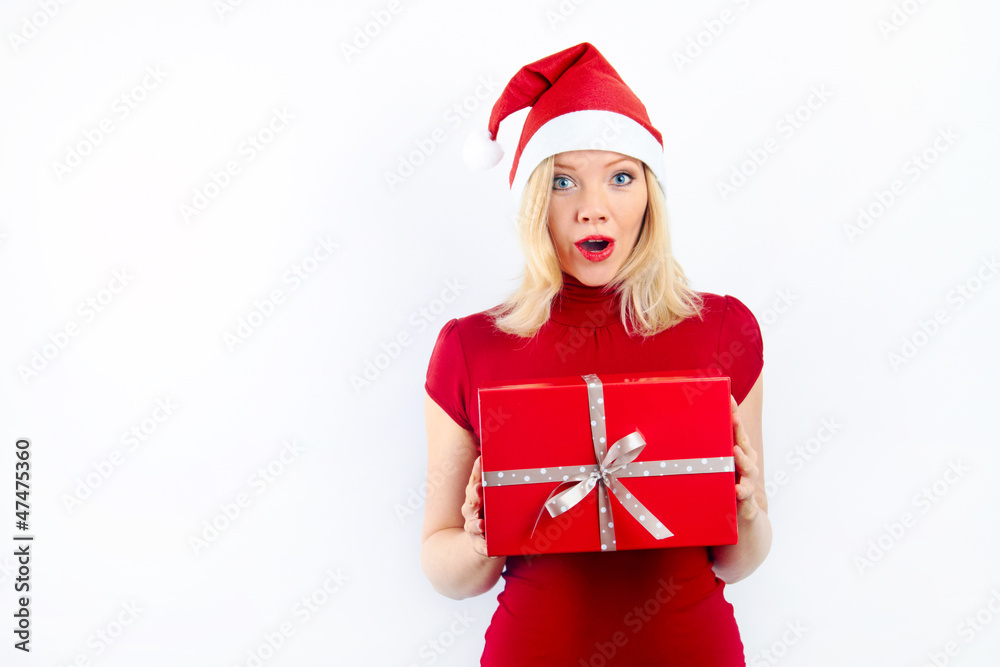 pretty blonde girl holding a christmas present is smiling
