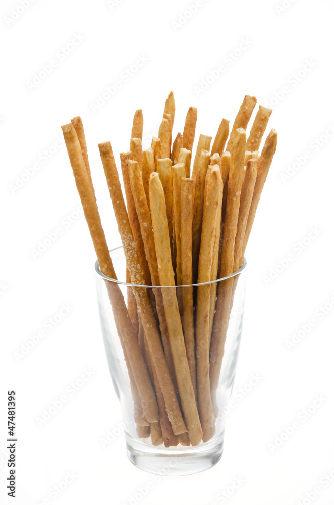 Bread sticks with salt in a glass beaker isolated