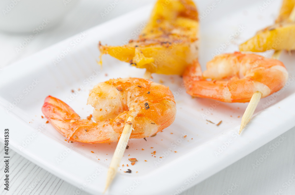 grilled shrimp and mango in the glaze closeup grilled shrimp and mango in the glaze closeup