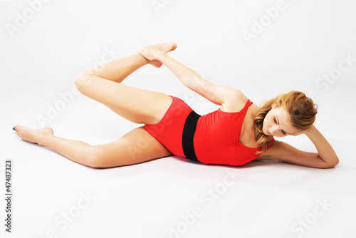 Beautiful sporty woman doing stretching exercise