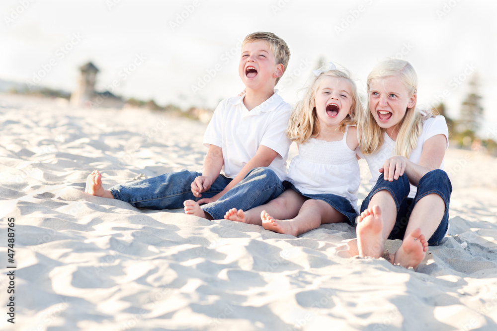 Cute Sibling Children Sitting at the Beach Cute Sibling Children Sitting at the Beach