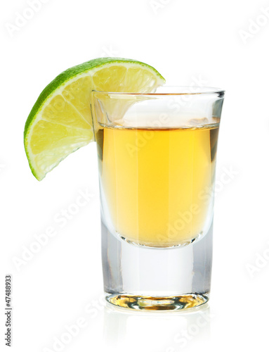 Shot of gold tequila with lime slice