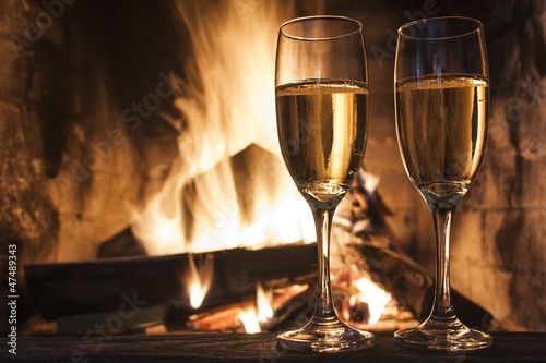 glasses of champagne in front of fireplace
