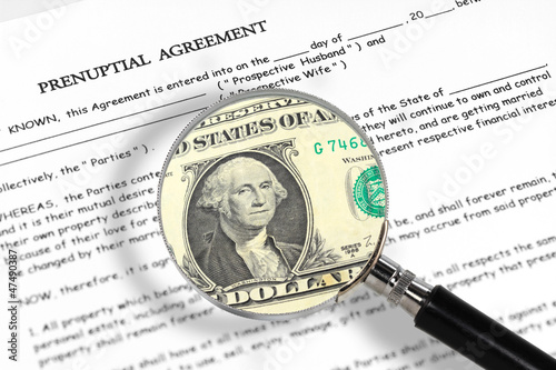 prenuptial agreement , magnifying glass and dollar note